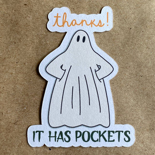 The Thanks! It Has Pockets Ghost sticker features a cartoon ghost with hands in its pockets saying “thanks!” above its head. Drawn on a brown paper background, this eco-friendly sticker is perfect for your collection.