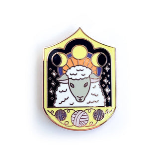 The Cosmic Sheep Enamel Pin is a limited edition, shield-shaped pin in black, yellow, and purple featuring a stylized sheep with curly wool, yarn balls, stars, and crescent moons—perfect for any cosmic sheep collector.