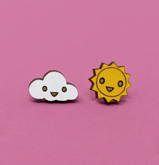 The ☀️ Sun & Cloud Earrings ☁️ feature a smiling white cloud and a cheerful yellow sun with cute faces, shown on a pink background.