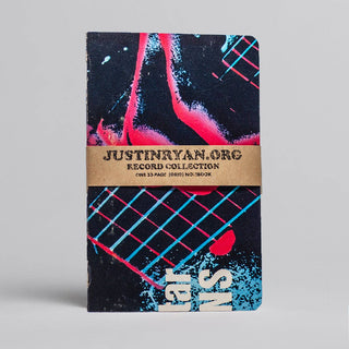 The Vintage Vinyl Pocket Notebook features a dark, abstract cover with red, blue, and white splashes and grid patterns. It comes with a brown band labeled JUSTINRYAN.ORG RECORD COLLECTION ONE 32-PAGE (GRID) NOTEBOOK.