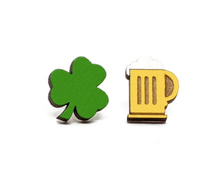 The Clover and Beer Earrings feature a small green shamrock and a yellow beer mug with white foam, both handmade in the USA from sustainable wood, shown against a plain white background.