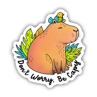 The Don't Worry, Be Capy Capybara and Bird Sticker features a calm cartoon capybara with a bird on its head among green leaves and the phrase "Don't worry, be capy," making a cute, waterproof vinyl reminder for mental health awareness.