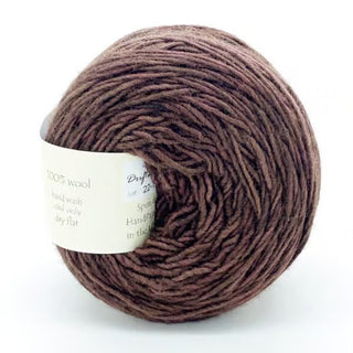 A round ball of brown Freia Semi-Solid Sport Wool Yarn, made from 100% US wool, with a white label, shown against a plain white background.