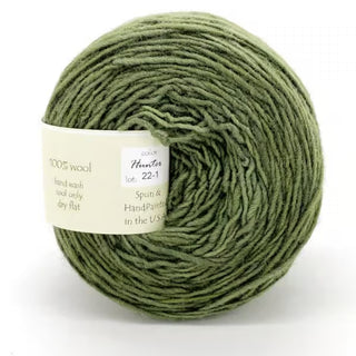 Freia Semi-Solid Sport Wool Yarn: a soft, textured single-ply sport weight yarn, 100% US wool, spun and hand-painted in the USA. Includes care instructions. Neatly wound ball in green shade.