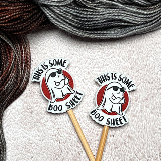 Add some flair to your knitting with Knitting Needle Stitch Stoppers—two needles topped with ghost sunglasses and the phrase "THIS IS SOME BOO SWEET." Includes textured yarn and fun silicone stitch stoppers for quirky crafters.