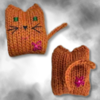 Two orange Tatters the Cat Poppet knitted toys, one showing a face with embroidered features and the other showing a curled tail and a pink stitched flower.