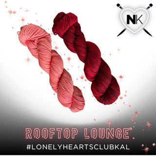 Two skeins of Superwash Merino Lazy Bee Yarn in Rooftop Lounge—light pink and deep red—rest on a white background with a heart logo, knitting needles, and “Rooftop Lounge #LonelyHeartsClubKAL.” Perfect for your Lonely Hearts Club KAL Kit!.