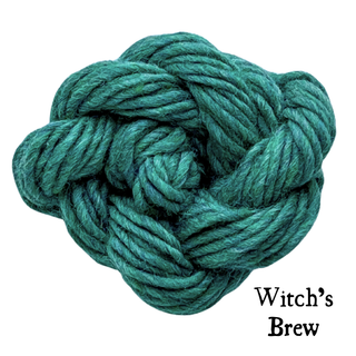 A knot of dark teal yarn labeled Witchs Brew for the Tatters the Cat Poppet | Knitting Kit.