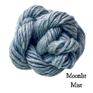A ball of heathered blue yarn labeled Moonlit Mist for a Tatters the Cat Poppet | Knitting Kit.