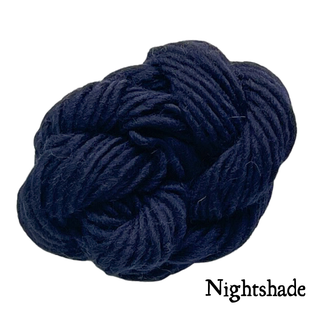 A ball of dark navy Nightshade yarn for a Tatters the Cat Poppet | Knitting Kit.