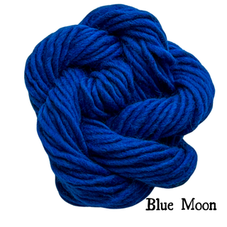 A ball of thick, royal blue yarn twisted into a knot for the Tatters the Cat Poppet | Knitting Kit, with the text Blue Moon in the bottom right corner.