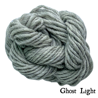 A ball of grey yarn labeled Ghost Light, part of the Tatters the Cat Poppet | Knitting Kit.