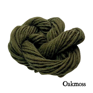 A coiled bundle of olive green Oakmoss yarn for the Tatters the Cat Poppet knitting kit.