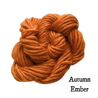 A tangled ball of thick, orange yarn for a Tatters the Cat Poppet | Knitting Kit with the text Autumn Ember to its lower right.