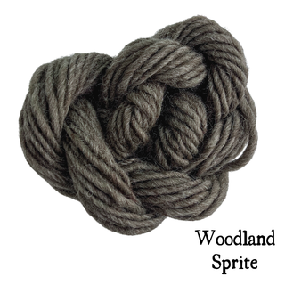 A tangled ball of dark gray yarn for the Tatters the Cat Poppet | Knitting Kit, with the text Woodland Sprite in the bottom right corner.