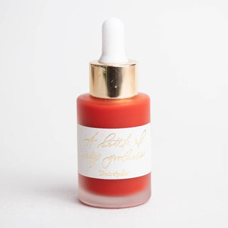 A small frosted glass dropper bottle of Premium Calligraphy Ink in red, featuring a gold and white dropper cap and a white label with gold cursive text, shown on a plain white background.