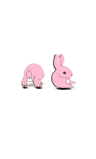 The Bunny Butt Earrings feature a cute bunny design with pink enamel on a white background. Handmade in the USA, these charming earrings showcase the playful style of a bunny's backside and add a touch of whimsy to any look.