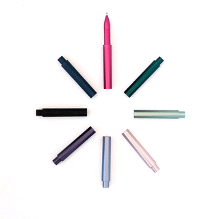 Eight colorful pen caps are arranged in a circle on a white background, with The Wren Refillable Writing Pen in pink at the center pointing upward, creating a clock face effect.