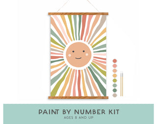 The Smiley Sunshine Paint-by-Number Kit for Kids features a smiling sun with pastel rays, includes paint pots and two brushes, and is perfect for ages 8+. A fun way to encourage creativity without screens!.