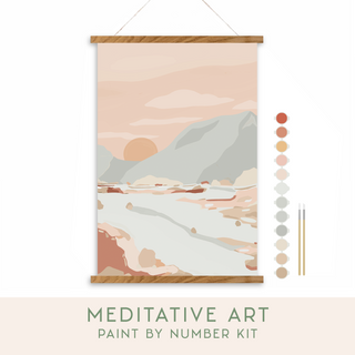 The Walk in Nature Meditative Art Paint by Number Kit includes a serene mountain landscape in pastel hues, numbered paint pots, three brushes, and the kit name beneath the artwork—perfect for mindful, calming creativity.