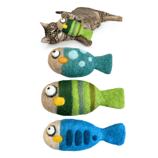 A tabby cat lies on its back playing with a green Felted Fish Cat Toy. Below, three more handmade wool Felted Fish Cat Toys in blue, green, and beige are arranged vertically on a white background.