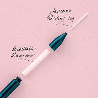 The Wren - Refillable Writing Pen is shown disassembled on a pink background, with handwritten labels highlighting each eco-friendly part—including its Japanese-made writing tip and reservoir.