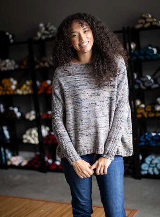 Kayla Maressa modeling a cozy grey sweater knit in Magpie Fibers. The knitting pattern is by Melissa Kemmerer in issue four of Nomadic Knits boutique knitting magazine