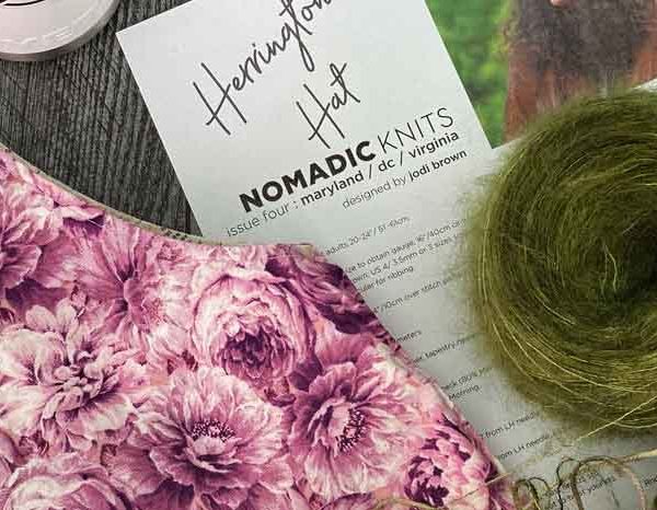 A knitting pattern by Jodi Brown of the Grocery Girls for Nomadic Knits knitting magazine; herrington hat knit with indie dyed yarn and topped with a pom pom