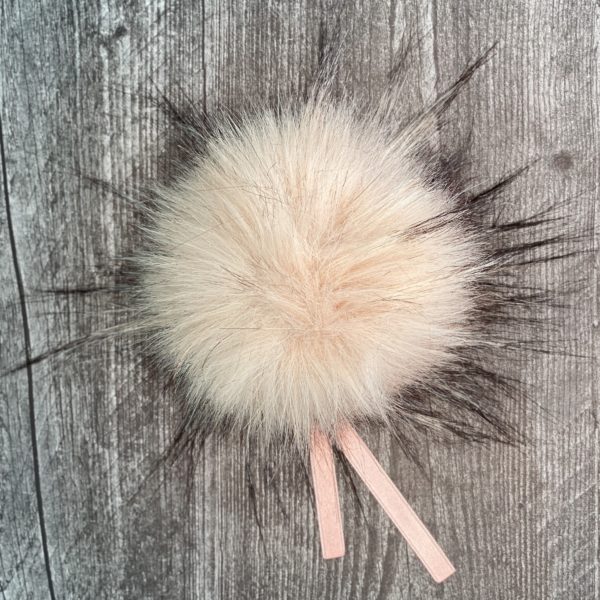 ikigai faux fur pom pom in Rose, with black tinged edges and pink ribbon ties