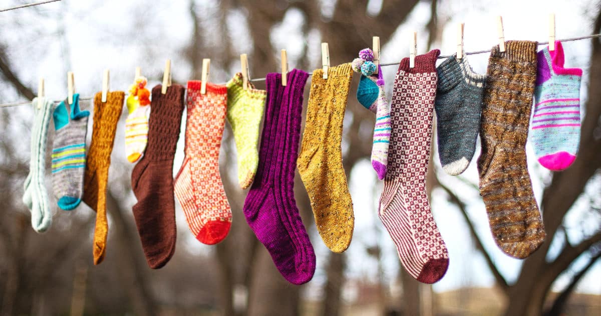 Hand knit socks hanging from a clothesline
