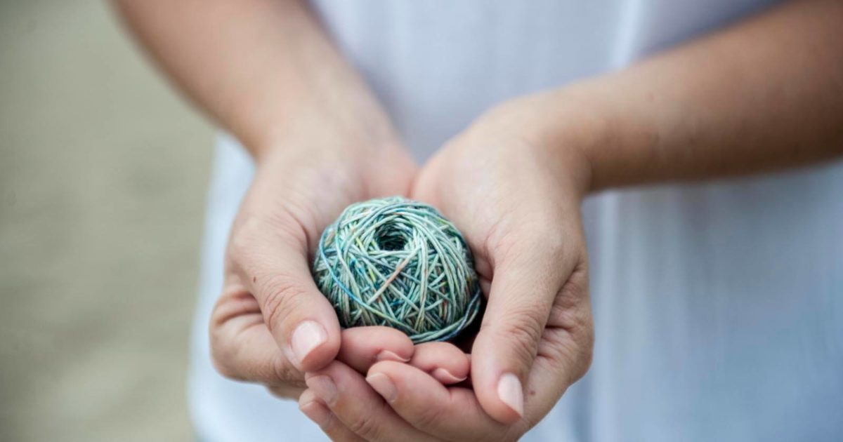Hands holding a ball of yarn