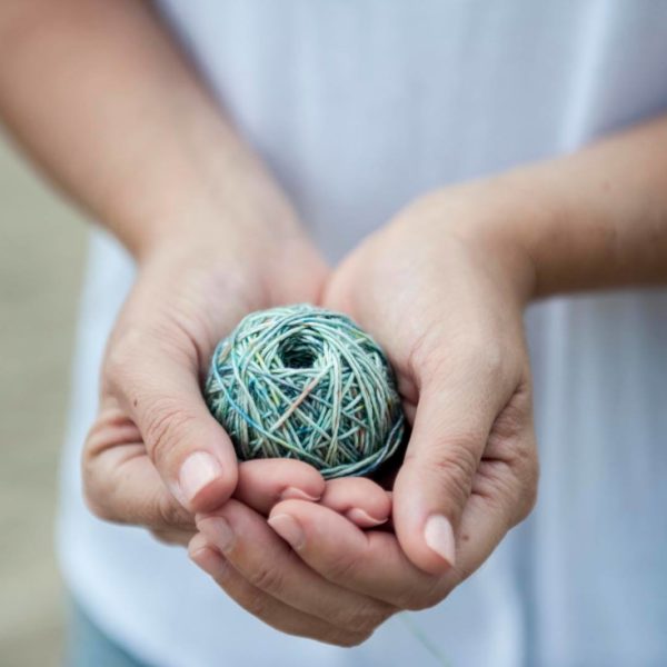 Hands holding a ball of yarn