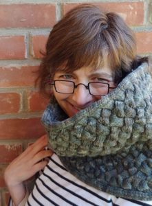 Kate Atherley wearing grey cowl designed by Ann Budd, using yarn from indie yarn dyer Briar Rose Fibers; knitting pattern found in Nomadic Knits creative knitting magazine