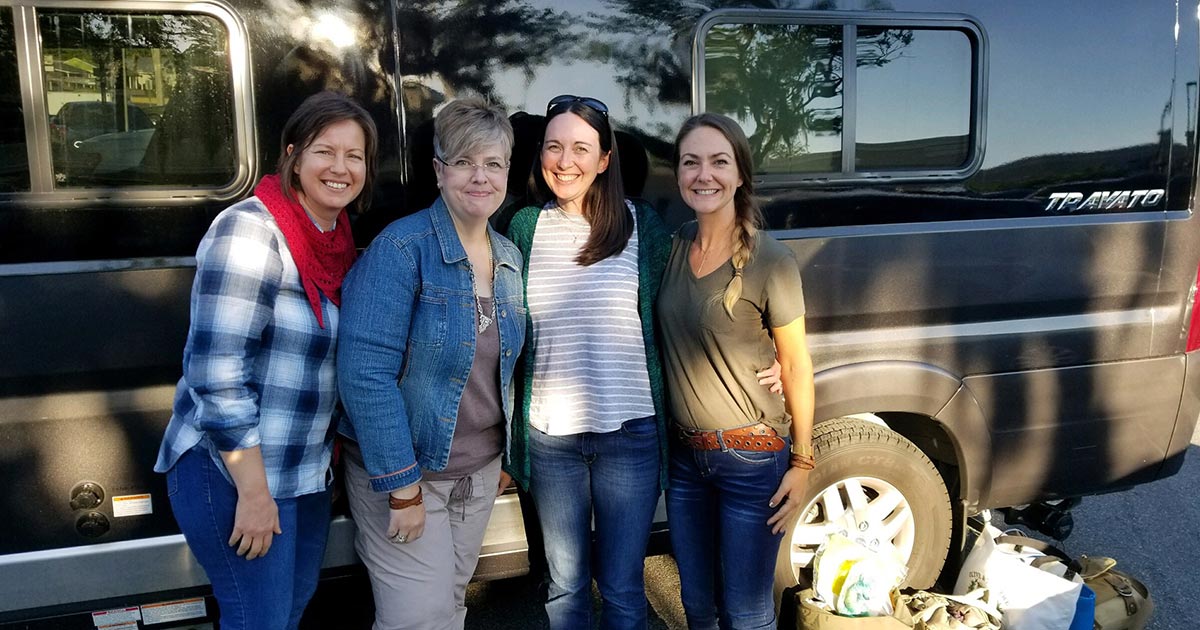 Becky and Melissa in front of van with Olive and Two crew